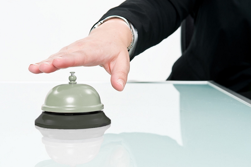 Person about to ring customer service bell